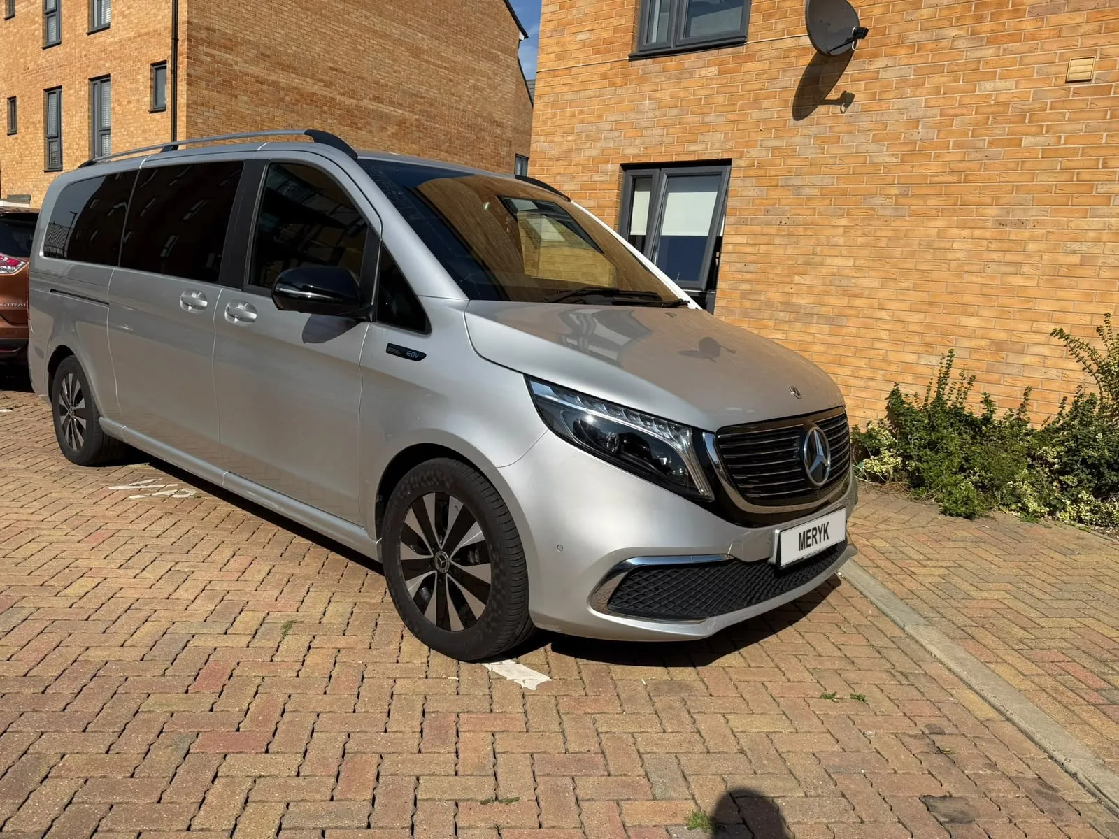 Silver Mercedes EQV people carrier with a MERYK number plate